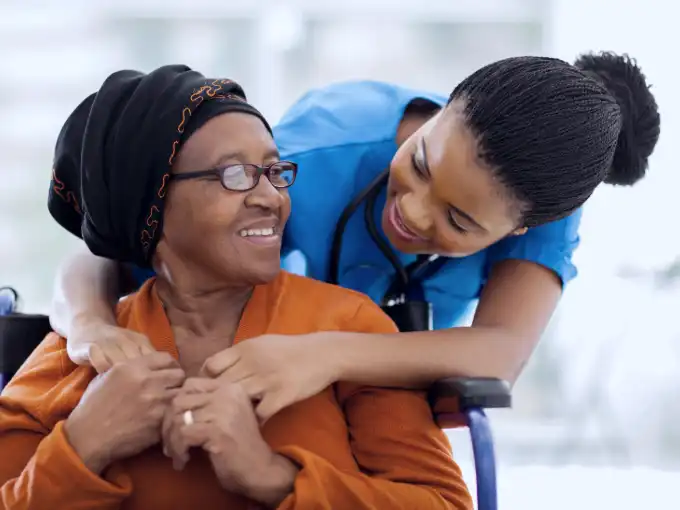 Nurse giving patient care to senior patient.